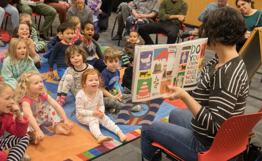 A librarian doing a storytelling among kids