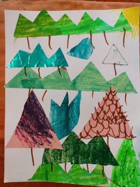 paper collage of trees made of triangles in varying sizes and colors